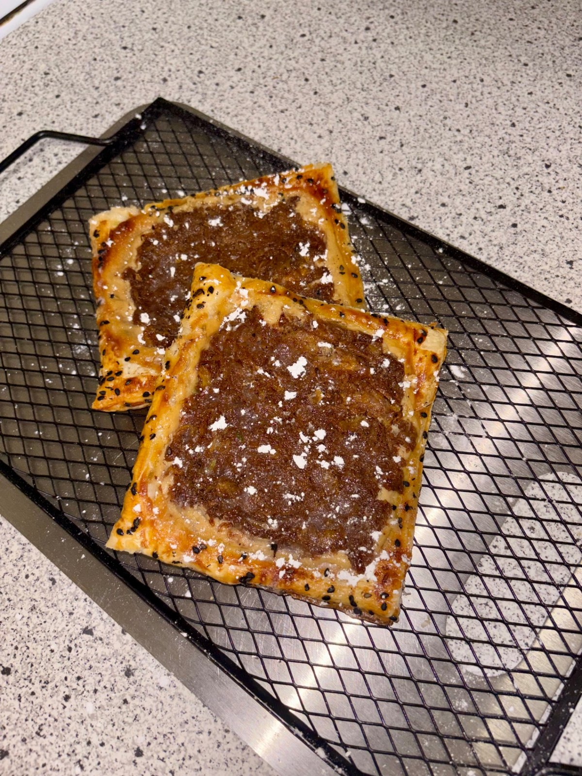 Plantain cream cheese danishes cooling on a black wire rack